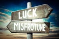 Luck, misfortune - wooden signpost, roadsign with two arrows