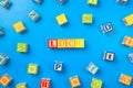 Luck. Wooden colorful alphabet blocks on blue background, flat lay, top view.