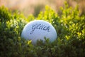 Luck written on clay ball, green background, meadow, fields