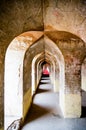 Vertical shot of an arched hallway of an ancient building