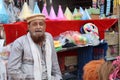 A tribal man from Northern Afghanistan is selling some stuff in his shop.