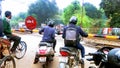 Lucknow, Uttar Pradesh, India - January 2020 : Motorcyclists waiting at the road intersection while the train passing