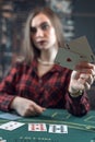 lucky beautiful brunette winning at poker game with two aces