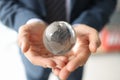 Lucky businessman holds glass globe with continents in hands Royalty Free Stock Photo