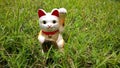 lucky cat, japanese doll ingot mean symbol good luck charm. closeup white figurine known as Maneki Neko. Royalty Free Stock Photo