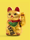 Lucky charm cat on yellow background