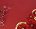 Lucky Chinese new year red background decoration with cherry blossom flower and paper fan