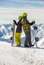 Lucky couple snowboarders