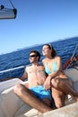 Lucky couple taking sun on sailing boat