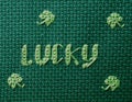 Lucky cross stitched in green on green