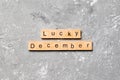 Lucky december word written on wood block. lucky december text on table, concept