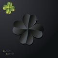 Lucky four-leaf clover leaf on dark background.