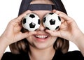 The lucky girl in the baseball cap closed her eyes with soccer balls.