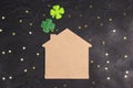 Lucky home symbol with four-leaf clover on black background with stars. St.Patrick`s day concept Royalty Free Stock Photo