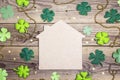 Lucky home symbol with four-leaf clover on wooden background. Co Royalty Free Stock Photo