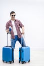 Overjoyed boy with suitcases and travel documents is eager to discover new destination and feelings. Royalty Free Stock Photo