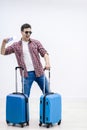 Overjoyed boy with suitcases and travel documents is eager to discover new destination and feelings. Royalty Free Stock Photo