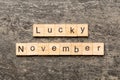 lucky november word written on wood block. lucky november text on table, concept Royalty Free Stock Photo