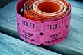 pink raffle tickets on wood