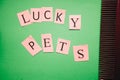 Lucky pets inscription on a green background