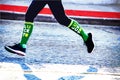 Lucky runner - legs and feet of marathon jogger in St Patrick`s Day race with green lucky socks