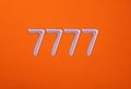 Lucky sevens - Numbers 7777 on orange background