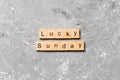 Lucky sunday word written on wood block. lucky sunday text on cement table for your desing, concept Royalty Free Stock Photo