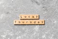 Lucky thursday word written on wood block. lucky thursday text on cement table for your desing, concept Royalty Free Stock Photo