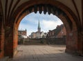 Luebeck, Germany. View of city through arch of famous Holsten gate Holstentor. Royalty Free Stock Photo