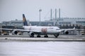 Lufthansa Airbus A340-600 D-AIHZ doing taxi Munich Airport,winter time, FC Bayern livery Royalty Free Stock Photo