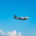 Lufthansa Airbus A320 flying by in white clouds and blue sky, landing at Larnaca International Airport Royalty Free Stock Photo