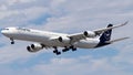 Lufthansa Airlines aircraft soaring against a blue sky backdrop.