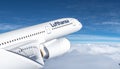 Lufthansa commercial Aeroplane flying in the sky above the mountains Royalty Free Stock Photo