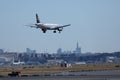 Lufthansa plane landing on Frankfurt Airport, FRA, buildings on background