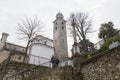 Tourists admiring the bell tower from Lugano Cathedral