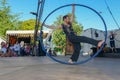 Acrobat on a hula hoop does tricks at Buskers Festival