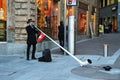 LUGANO, SWITZERLAND - NOVEMBER 27, 2017: Swiss musician with a typical Alphorn in Lugano city. A man in traditional Swiss costume