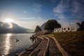 View of Lugano promenade at down with a swan swimming on lake, Switzerland