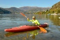 Man who is rowing in his canoe on lake of Lugano in Switzerland Royalty Free Stock Photo