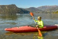 Man who is rowing in his canoe on lake of Lugano in Switzerland Royalty Free Stock Photo