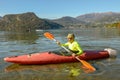 Man who is rowing in his canoe on lake of Lugano in Switzerland Royalty Free Stock Photo