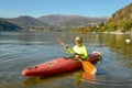 Man who is rowing in his canoe on lake of Lugano in Switzerland Royalty Free Stock Photo