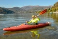 Man who is rowing in his canoe on lake of Lugano in Switzerland Royalty Free Stock Photo