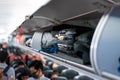 Luggage on airplane shelf overhead passenger seat