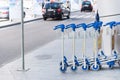 Luggage carts at the entrance of international airport terminal Royalty Free Stock Photo