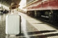 Luggage and hat are placed on platform in the train station, while awaiting trains with abstract concepts, learning and travel to
