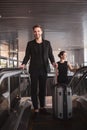 Man and woman carrying their suitcase through the escalator Royalty Free Stock Photo