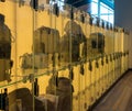 Luggage stored in transparent glass boxes in airport lounge