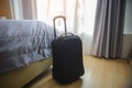 Luggage or Suitcase Bag with hat in Hotel room. Tourist depart from airport and arrive at resort bedroom to relax on vacation. Royalty Free Stock Photo