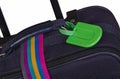 Luggage tag and colorful belt on suitcase Royalty Free Stock Photo